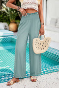 Dusty teal smocked wide-leg pants with side pockets, front view