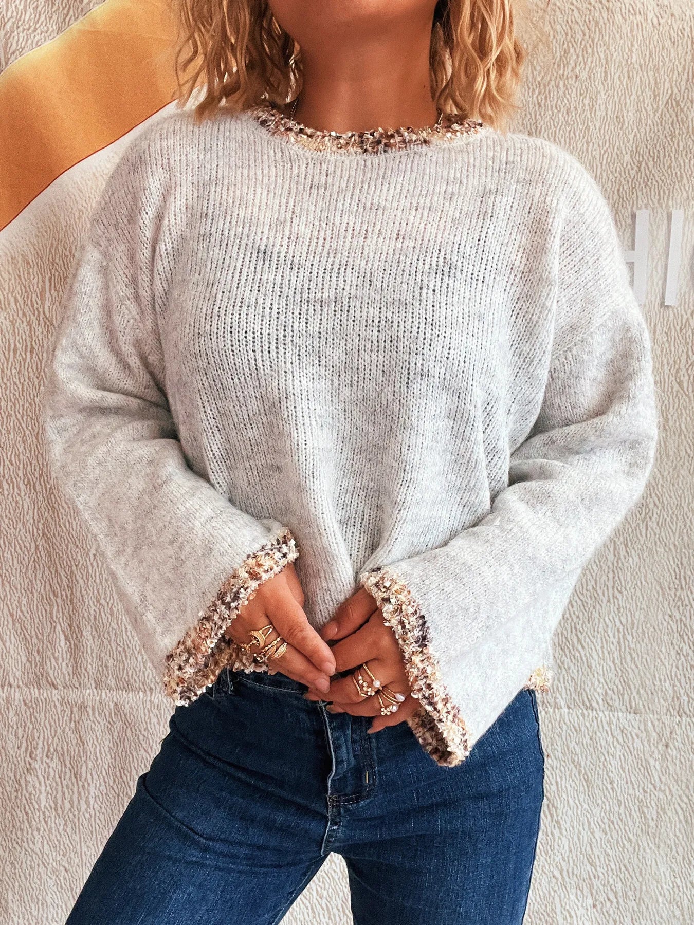 Light gray cropped round-neck knit sweater with sparkly trim at cuffs and hem