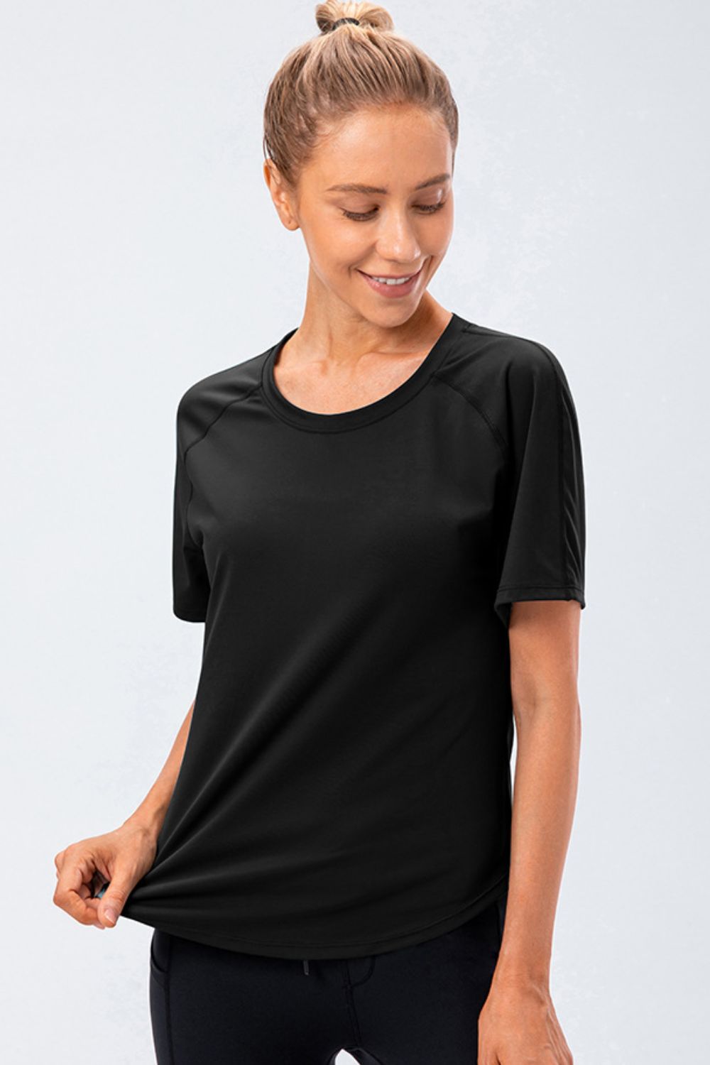 Black active tee with round neck and raglan sleeves, front view
