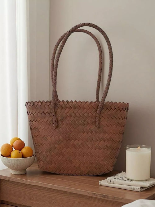 Brown braided tote bag with woven pattern and two long handles