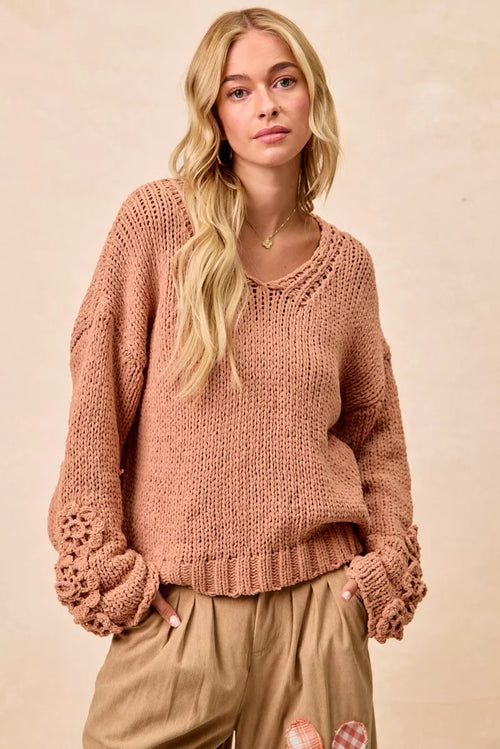 Dusty peach chunky knit sweater with floral lace sleeve cuffs and crew neck