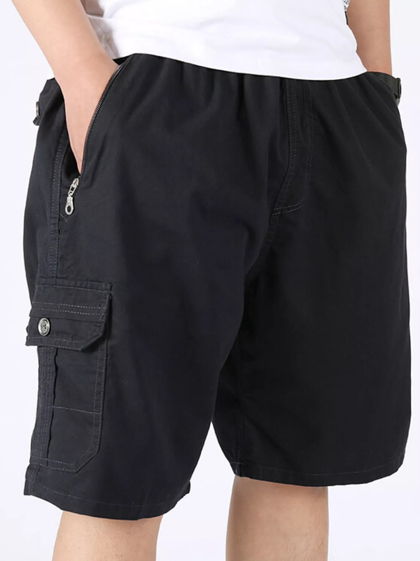 Black cargo shorts with side cargo pocket and zip fly.