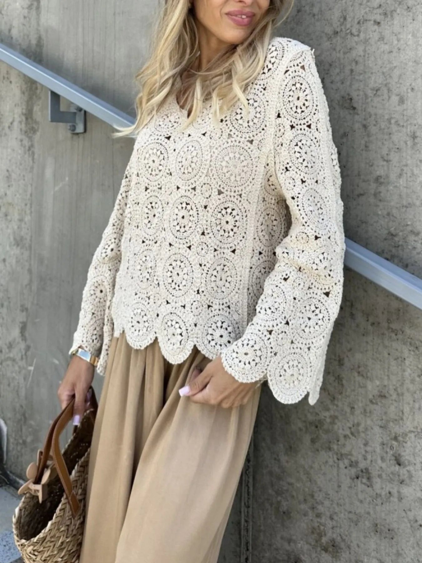 White crochet lace V-neck knit top with textured circular pattern and bell cuffs