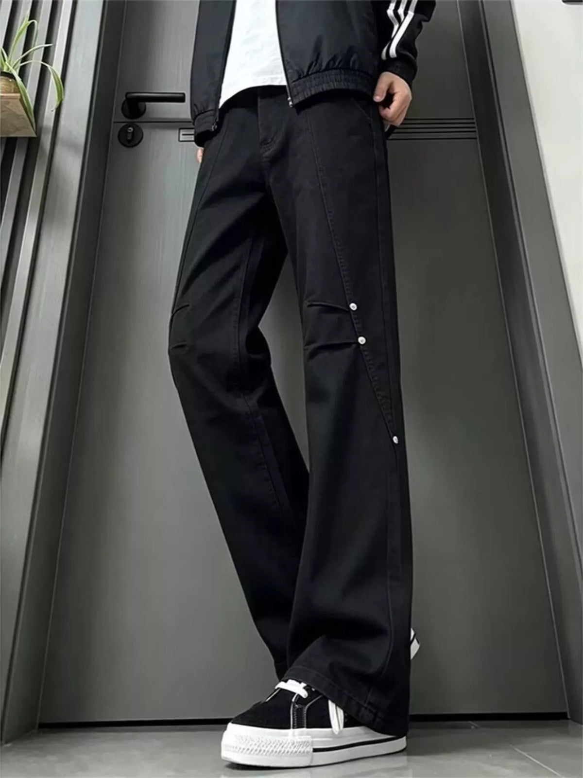Black wide-leg denim jeans with front pockets and buttoned side seams