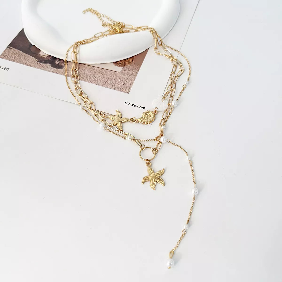 Gold layered starfish necklace with chain links and dangling pearl drop