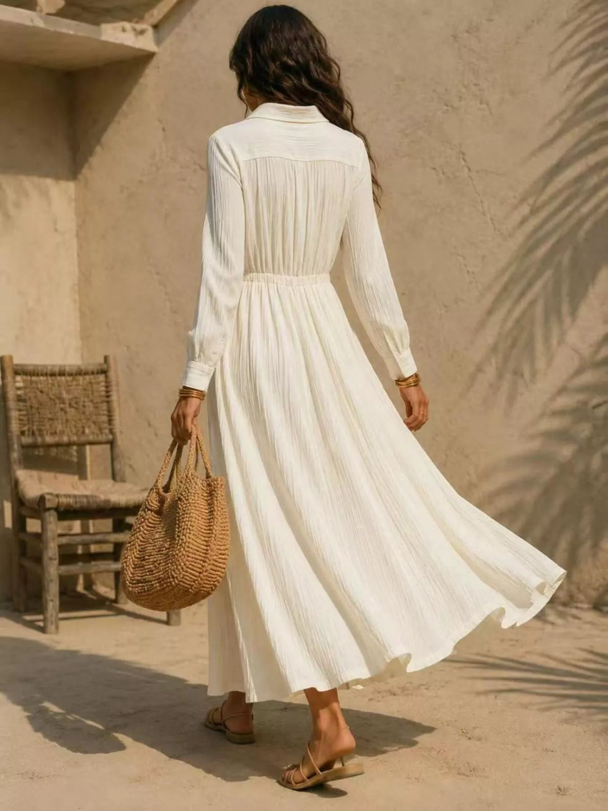 Cream maxi button-front shirtdress from back view with long sleeves and gathered waist seam