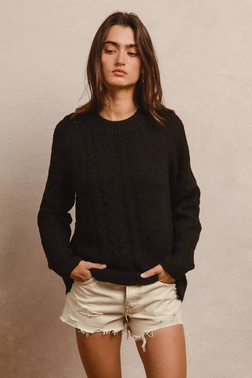 Black twist-knit sweater with crew neck and long sleeves