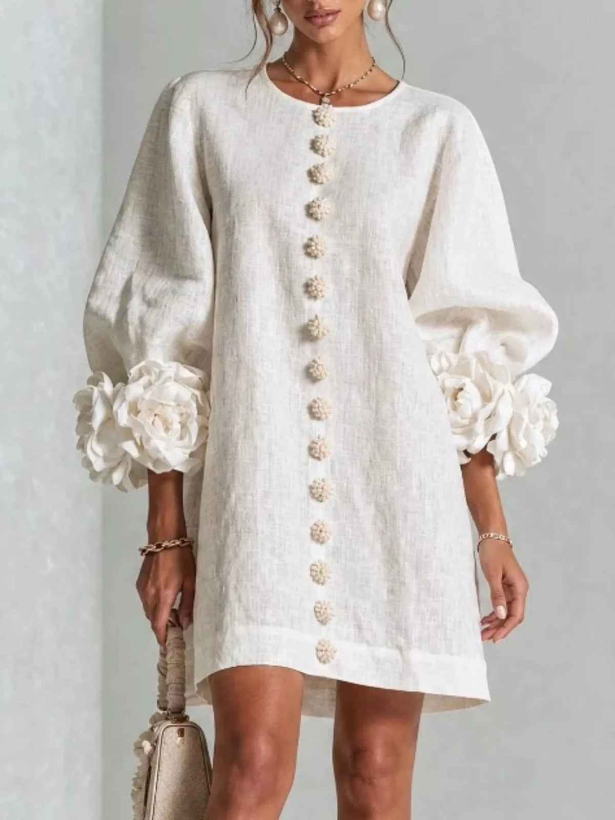 Off-white round-neck polyester dress with long balloon sleeves, floral cuff accents, button trim