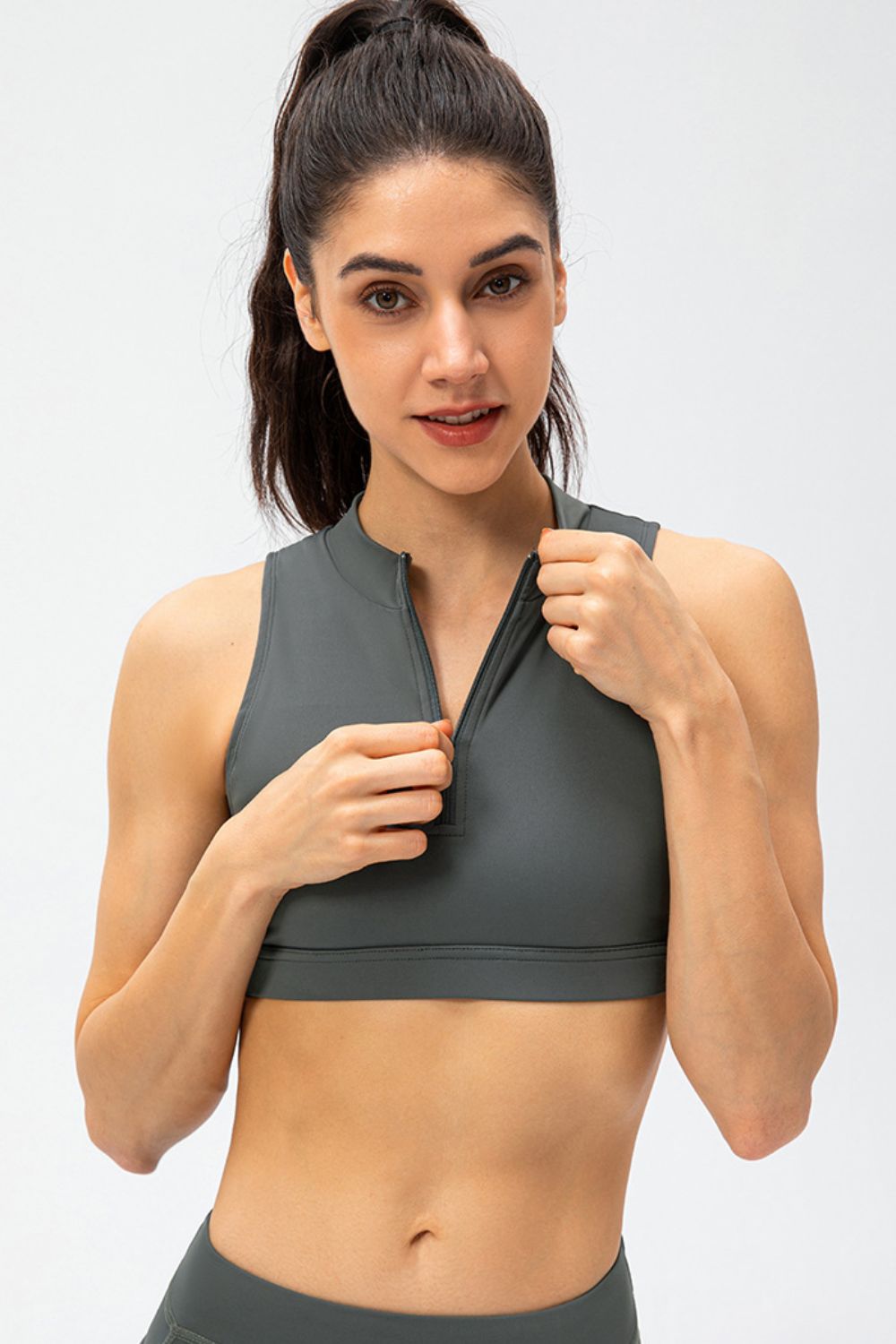 Dark gray cropped active tank top with front half-zip and sleeveless high neck
