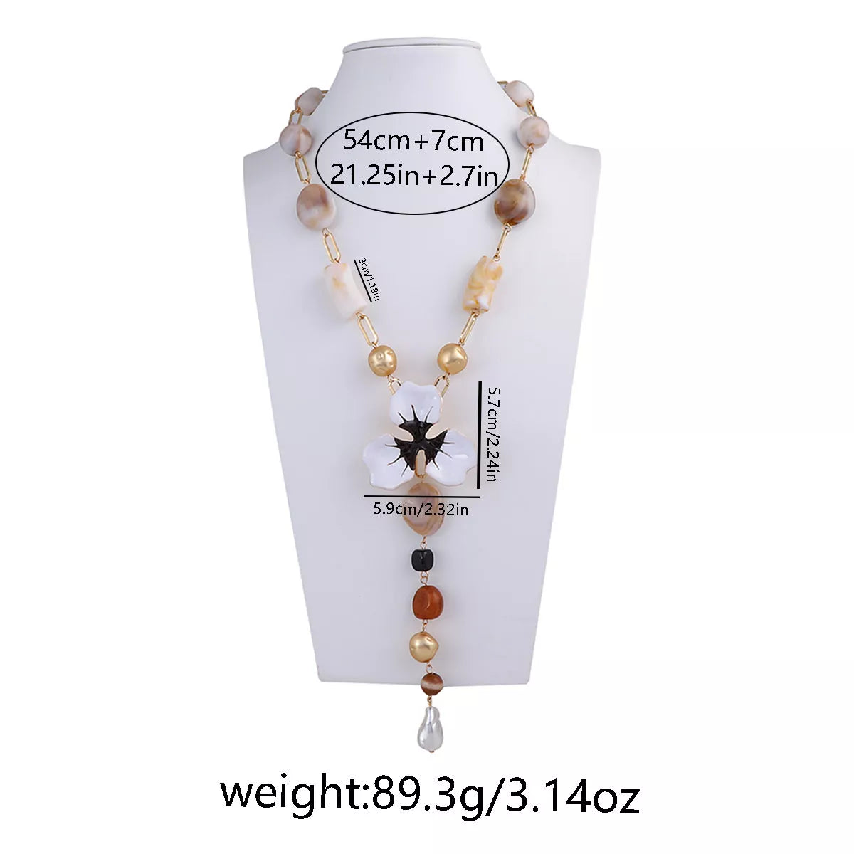 Y-shaped resin flower necklace on mannequin with white petals, black center, and bead tassel