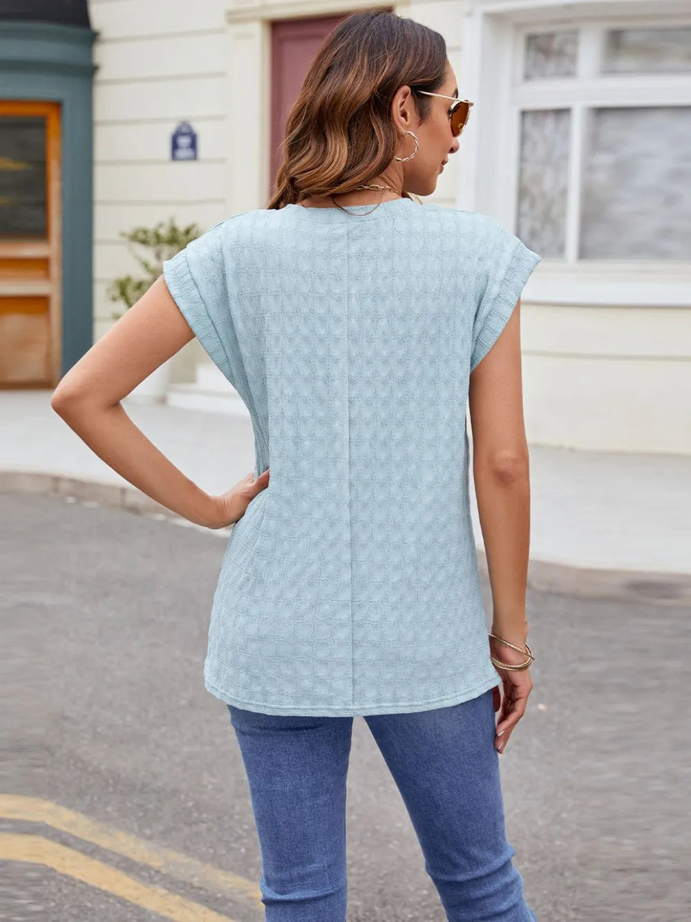 Light blue textured round-neck cap-sleeve T-shirt, back view with short sleeves