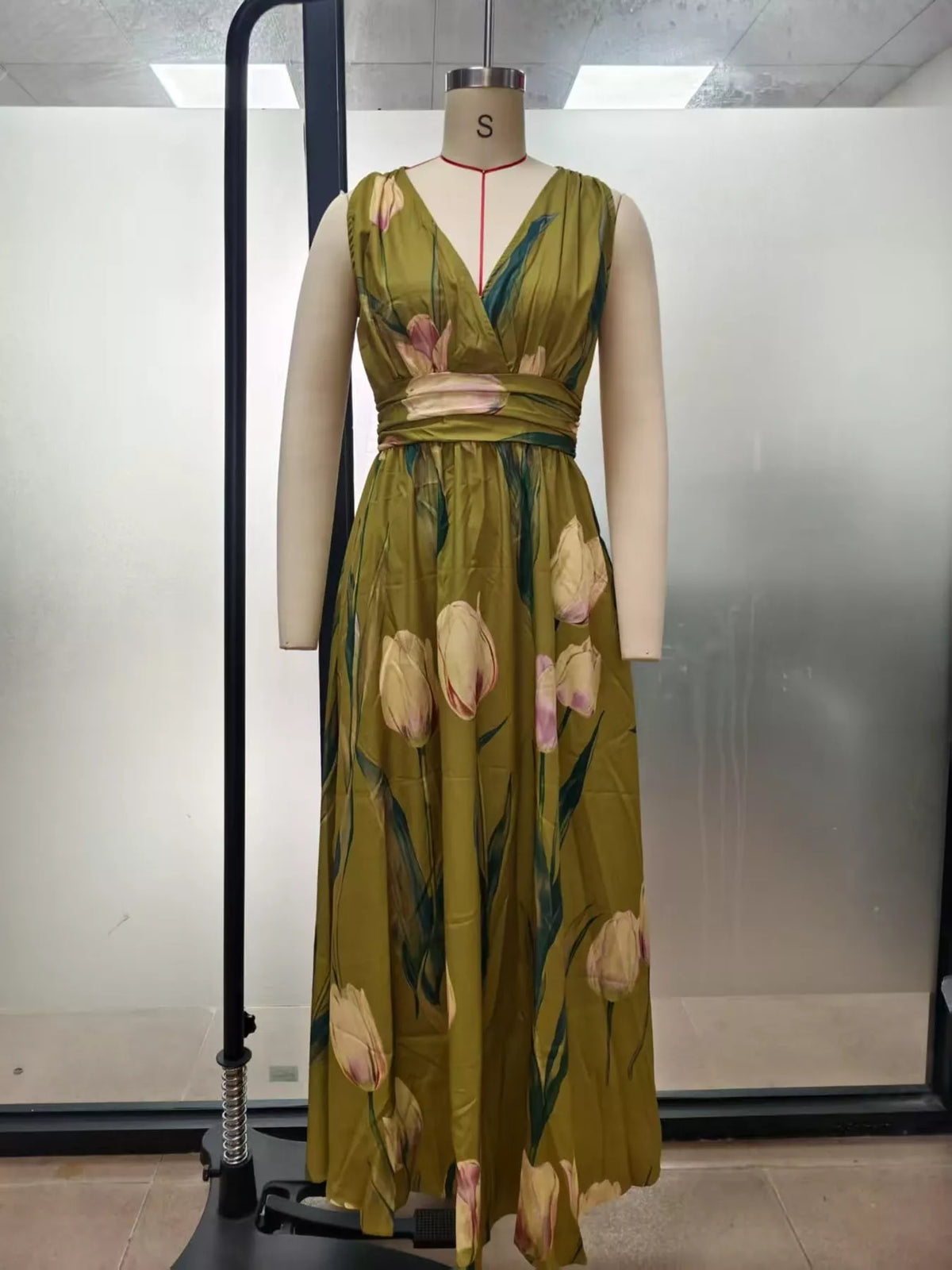 Olive green sleeveless floral maxi dress with V-neck and gathered waist