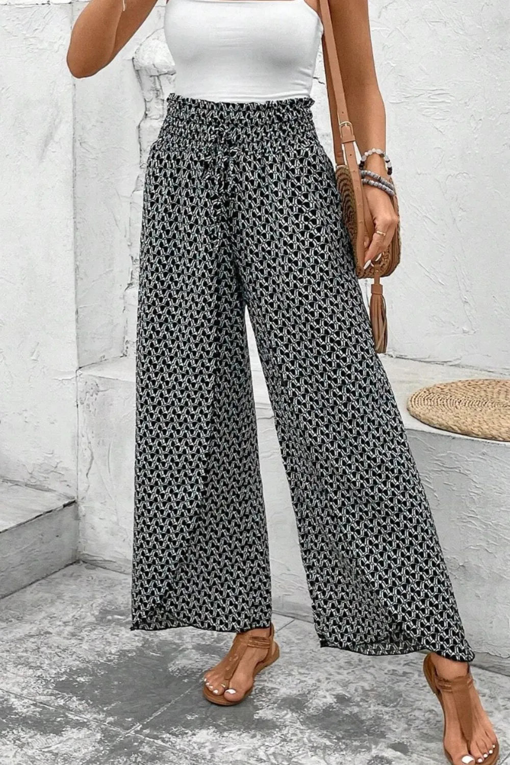 Black patterned wide-leg pants with elastic waist and flowing wide legs