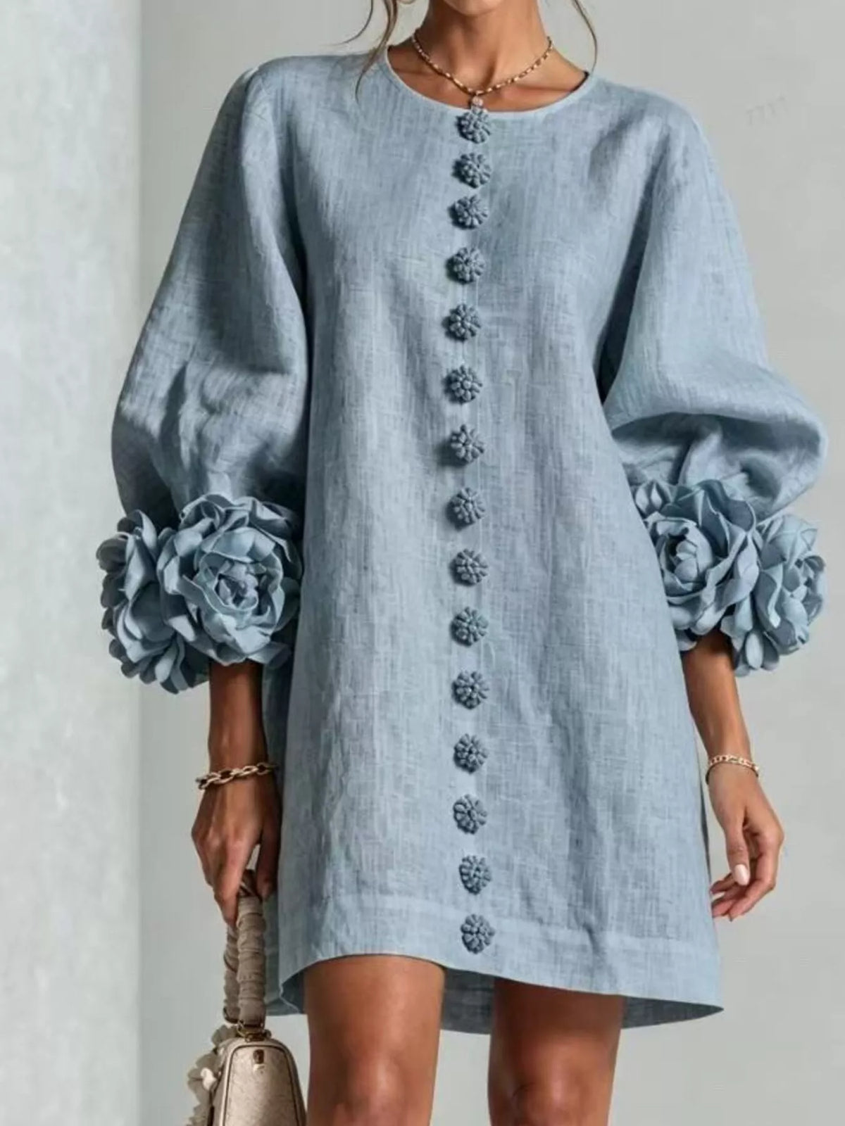 Light blue linen mini dress with 3D floral applique down front and rose puff sleeves