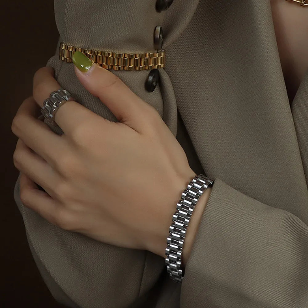 Silver chain bracelet with rectangular links, worn on wrist