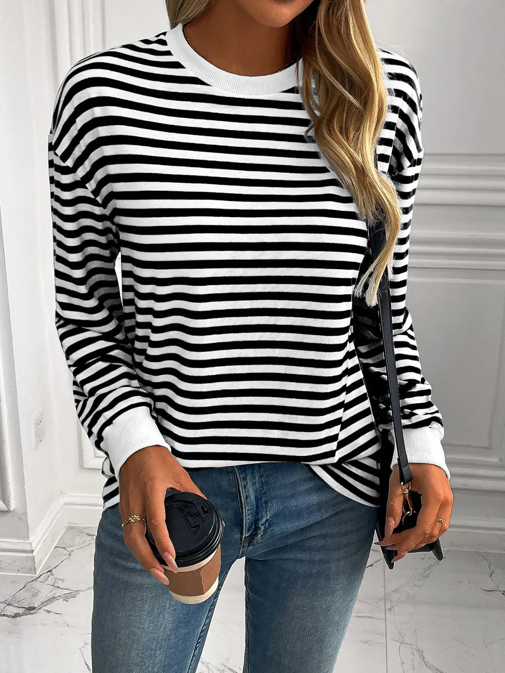 Striped crewneck long-sleeve sweatshirt in black and white, front view