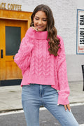 Hot pink cable-knit turtleneck sweater with long sleeves and textured cable pattern