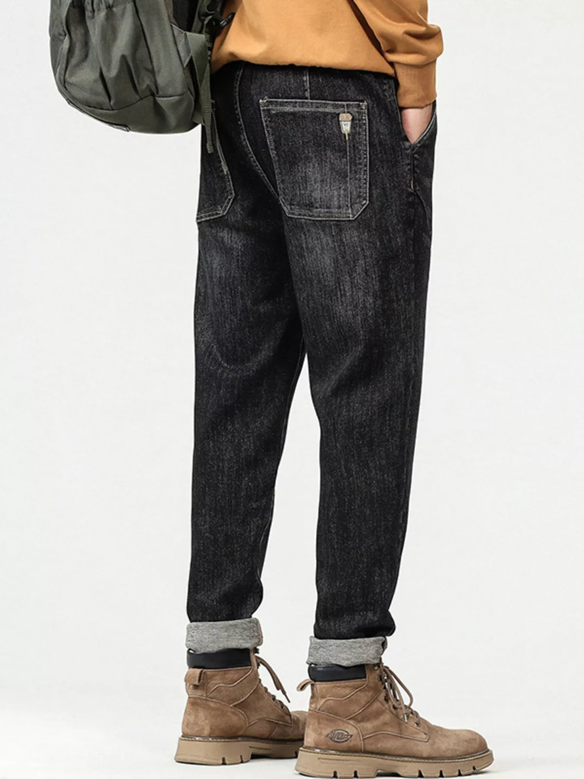 Men's relaxed fit vintage wash black cotton jeans, rear view with five-pocket styling