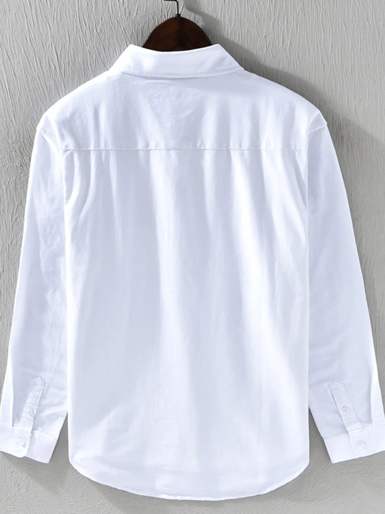 White button-down shirt with long sleeves and button placket, back view