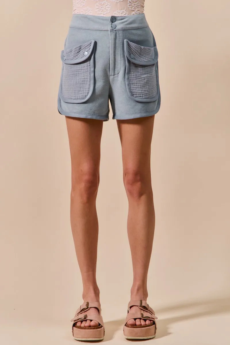 Denim blue mineral-washed terry high-rise cargo shorts with two large flap pockets
