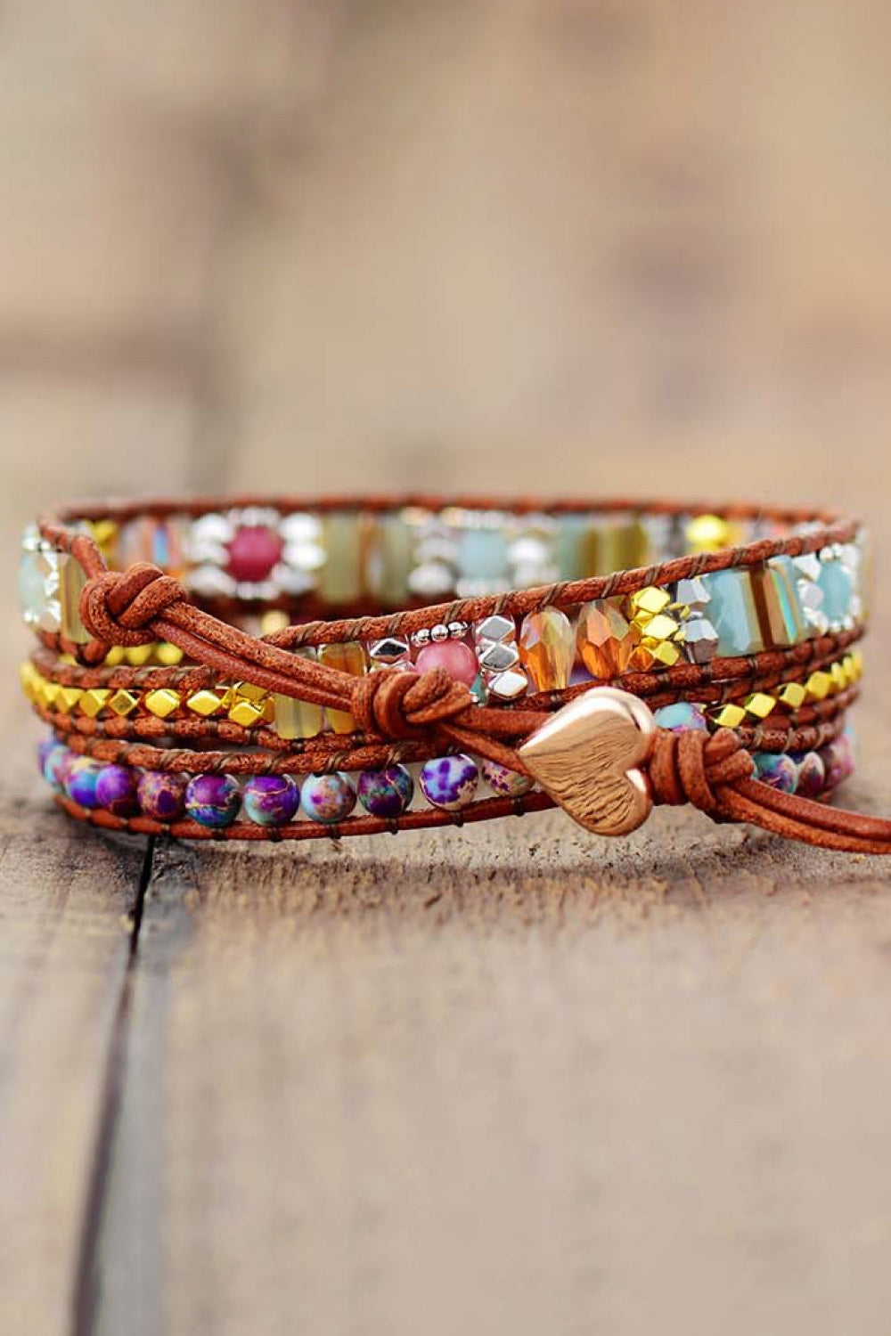 Beaded wrap bracelet with braided cord, white heart charm, and knot tie end