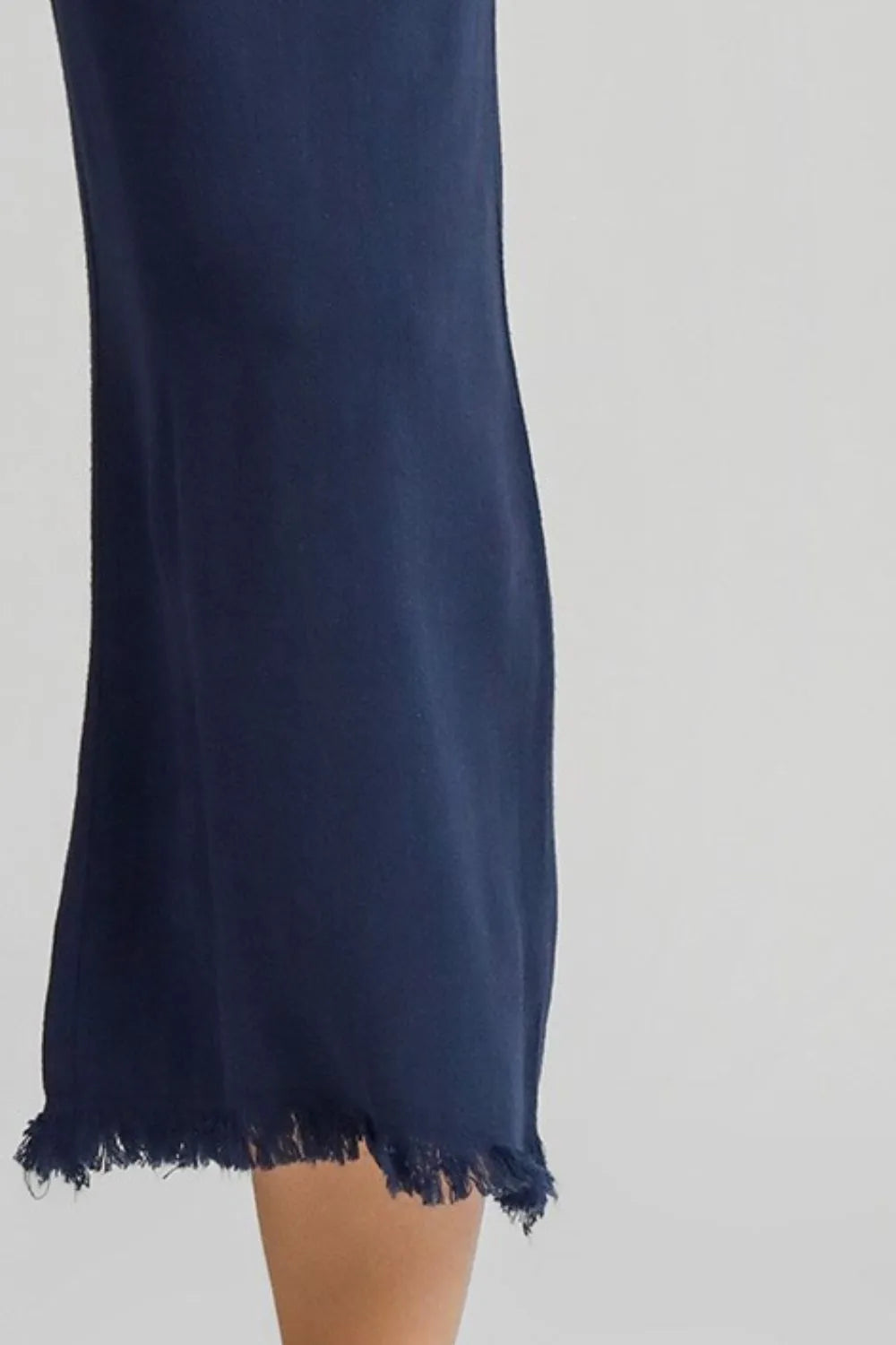 Dark blue wide-leg pants with frayed hem and cropped length.
