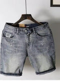 Light gray distressed denim shorts with belt loops, front button/zip closure, side pockets