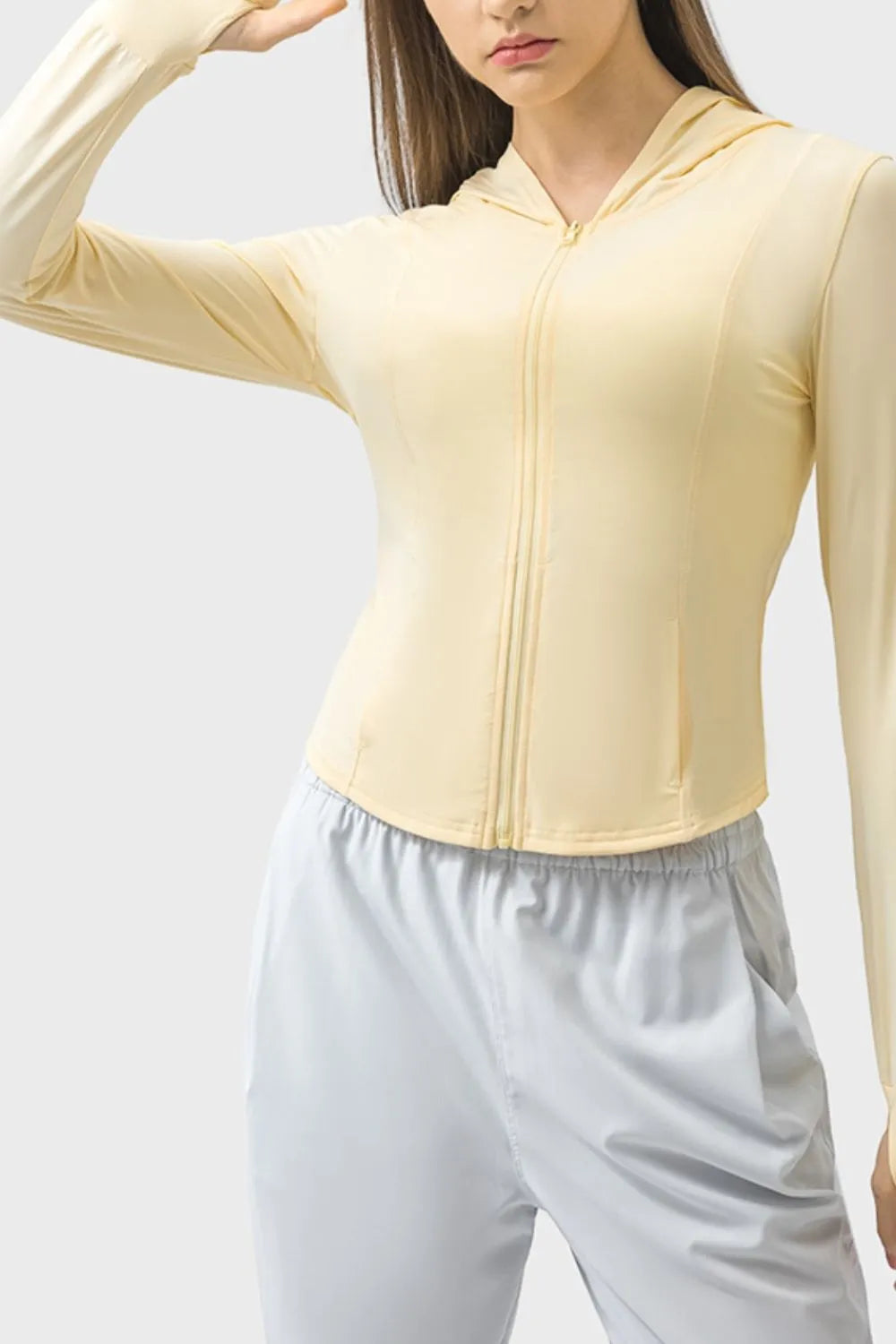 Light yellow zip-up hooded active jacket with front zipper and long sleeves