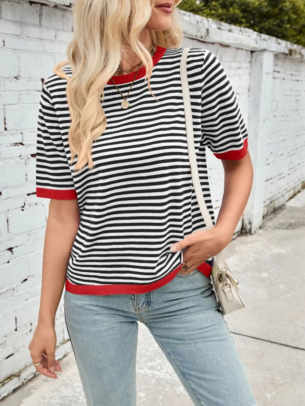Black-and-white striped knit top with red contrast crew neck, short sleeves, rib hem