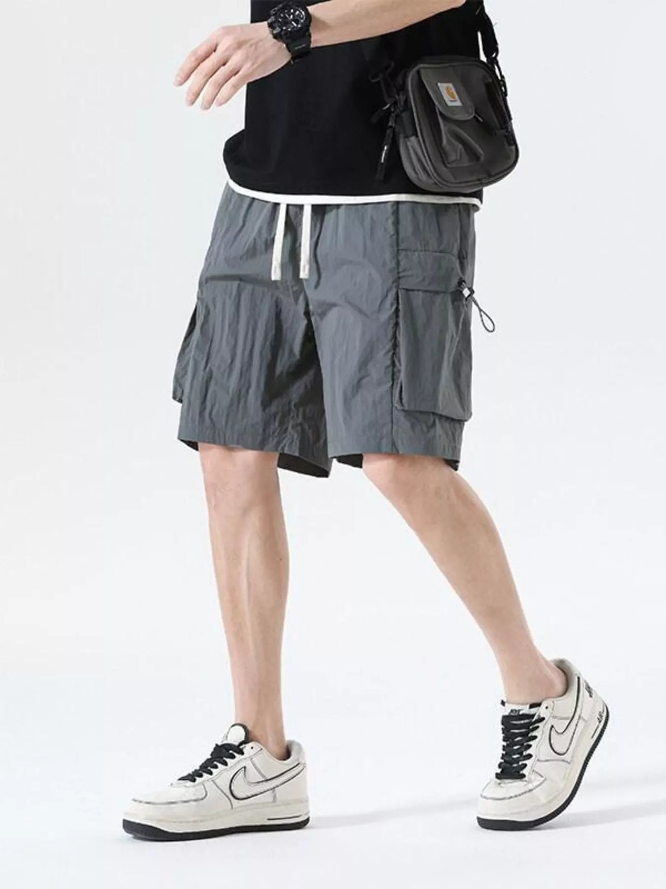 Grey drawstring cargo shorts with large side cargo pocket and flap