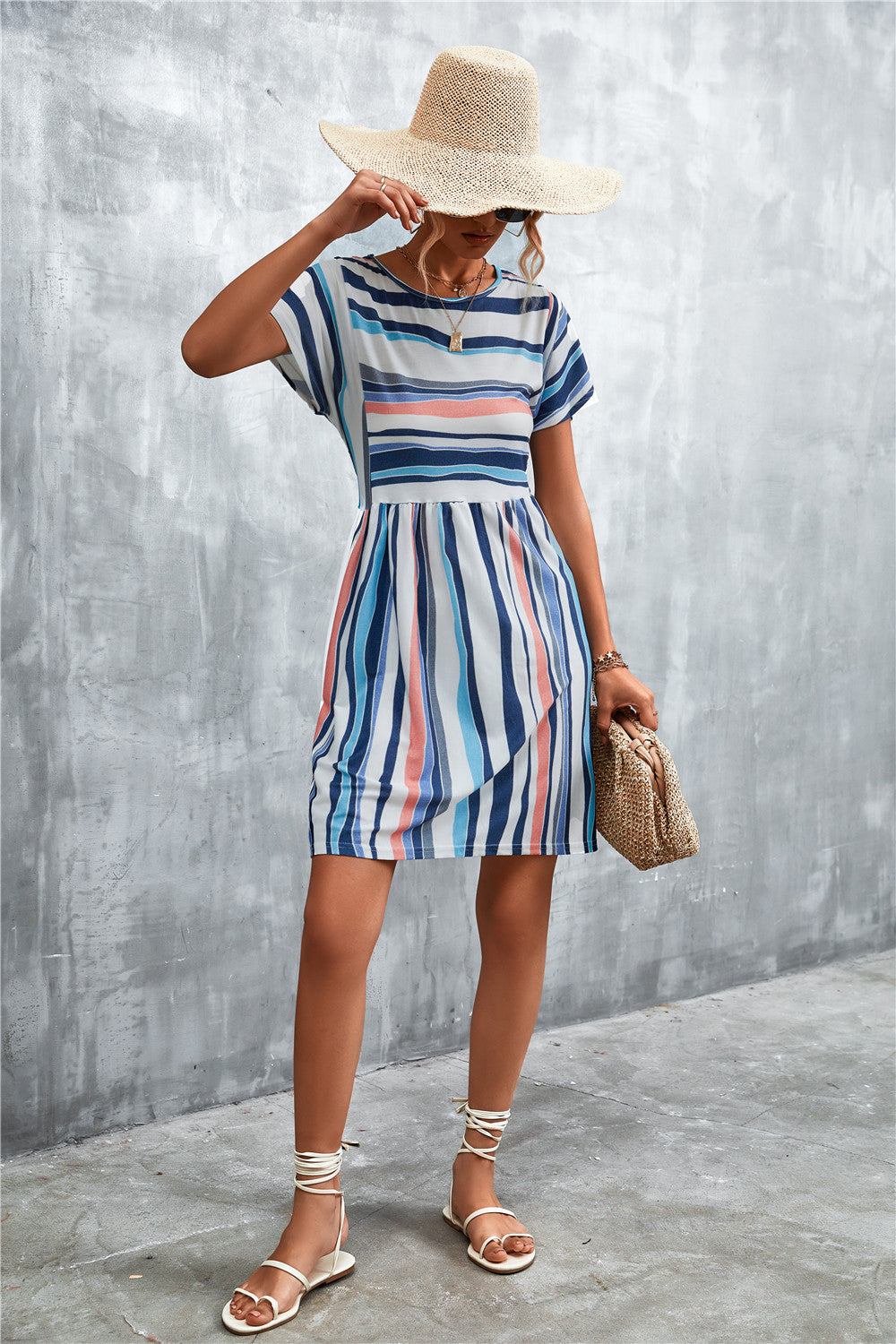 Striped round-neck dress with short sleeves, blue-and-white vertical stripes, above-knee hem