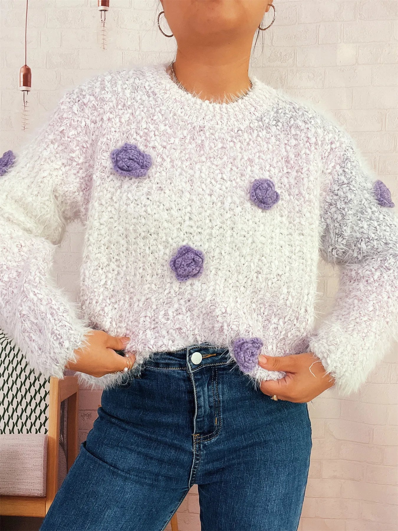 Flower-embellished round-neck sweater, fuzzy white knit with purple rosette details at chest
