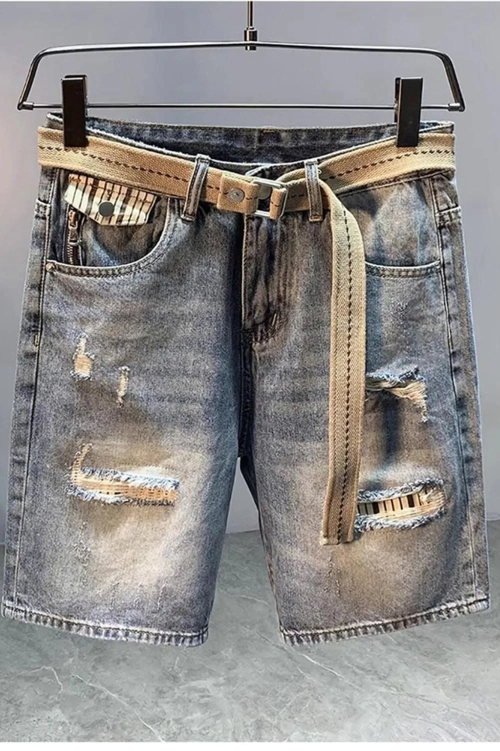 Men's distressed light blue denim shorts with drawstring tie and frayed rips