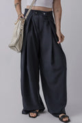 Dark navy wide-leg pants with pockets, pleated front and buttoned waistband.