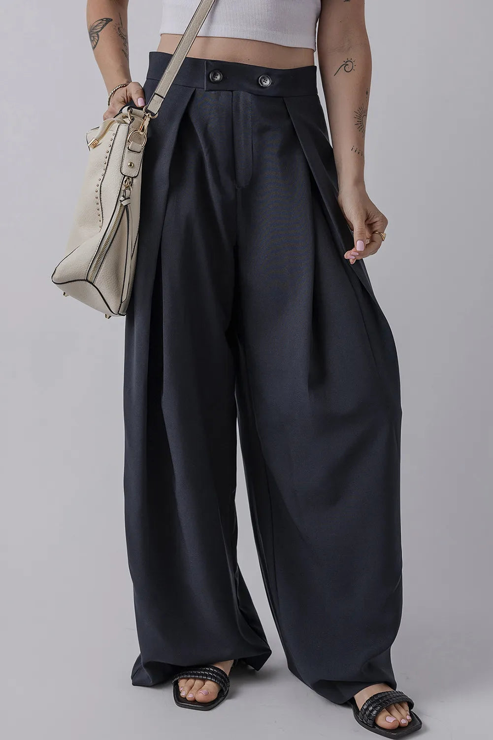 Dark navy wide-leg pants with pockets, pleated front and buttoned waistband.