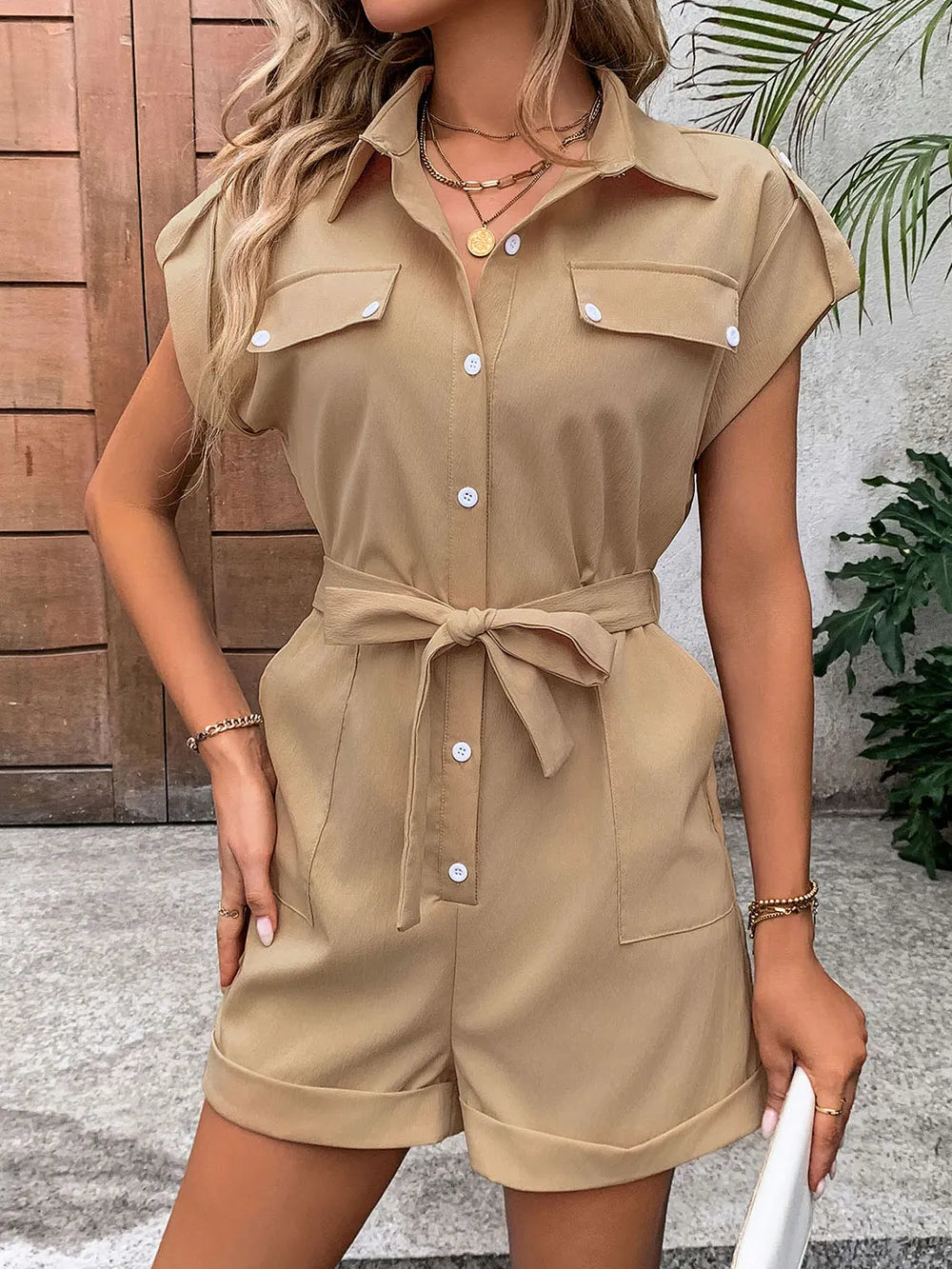 Camel collared button-front romper with tie waist and chest pockets, short sleeves