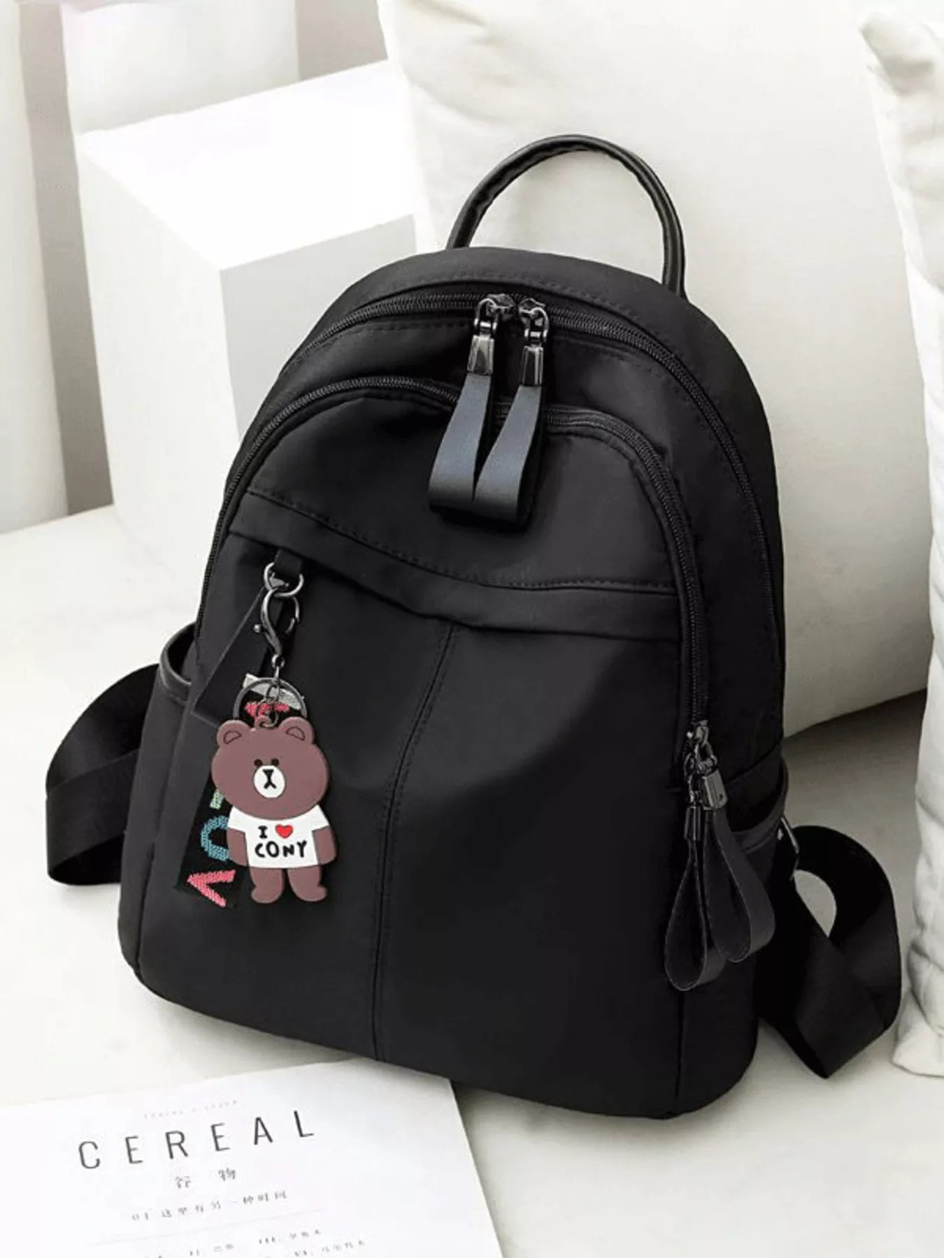 Cedar & Moore lightweight nylon mini backpack in black with dual zippers and top handle.