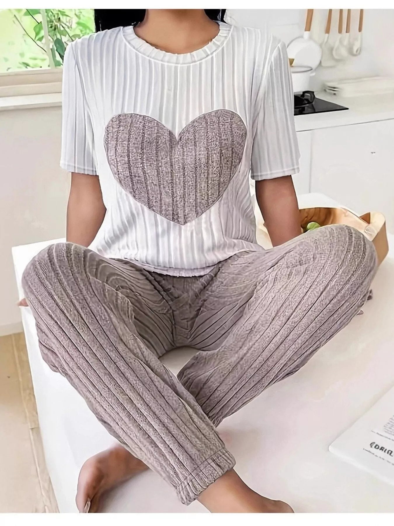 Heart ribbed knit lounge set with white striped top and mauve-gray pants, seated view
