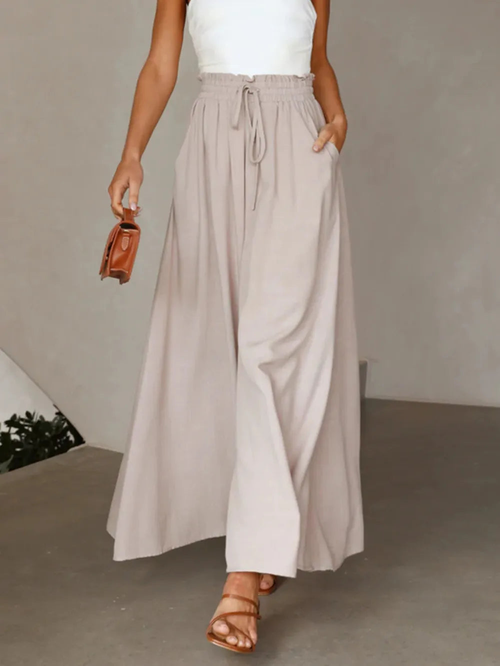High-waist wide-leg pants in light gray with elastic drawstring waist and relaxed wide-leg fit