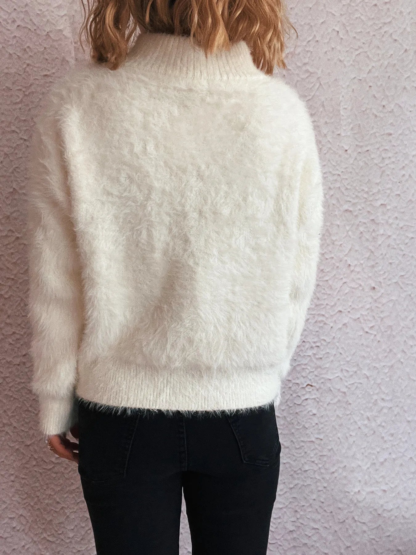 White fuzzy half-zip sweater, back view with ribbed hem