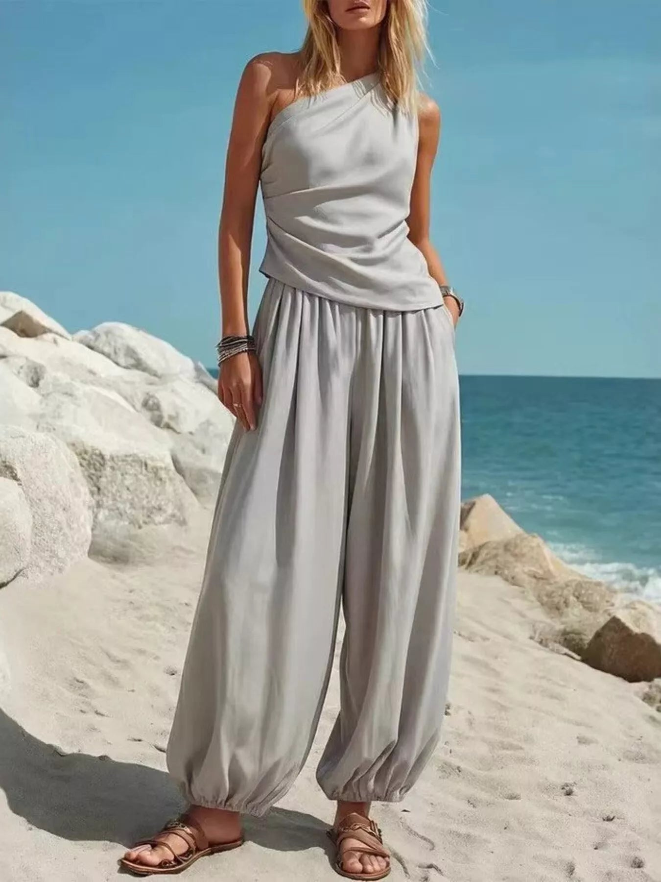 Light gray one-shoulder top and wide-leg pants set, draped bodice and gathered waist
