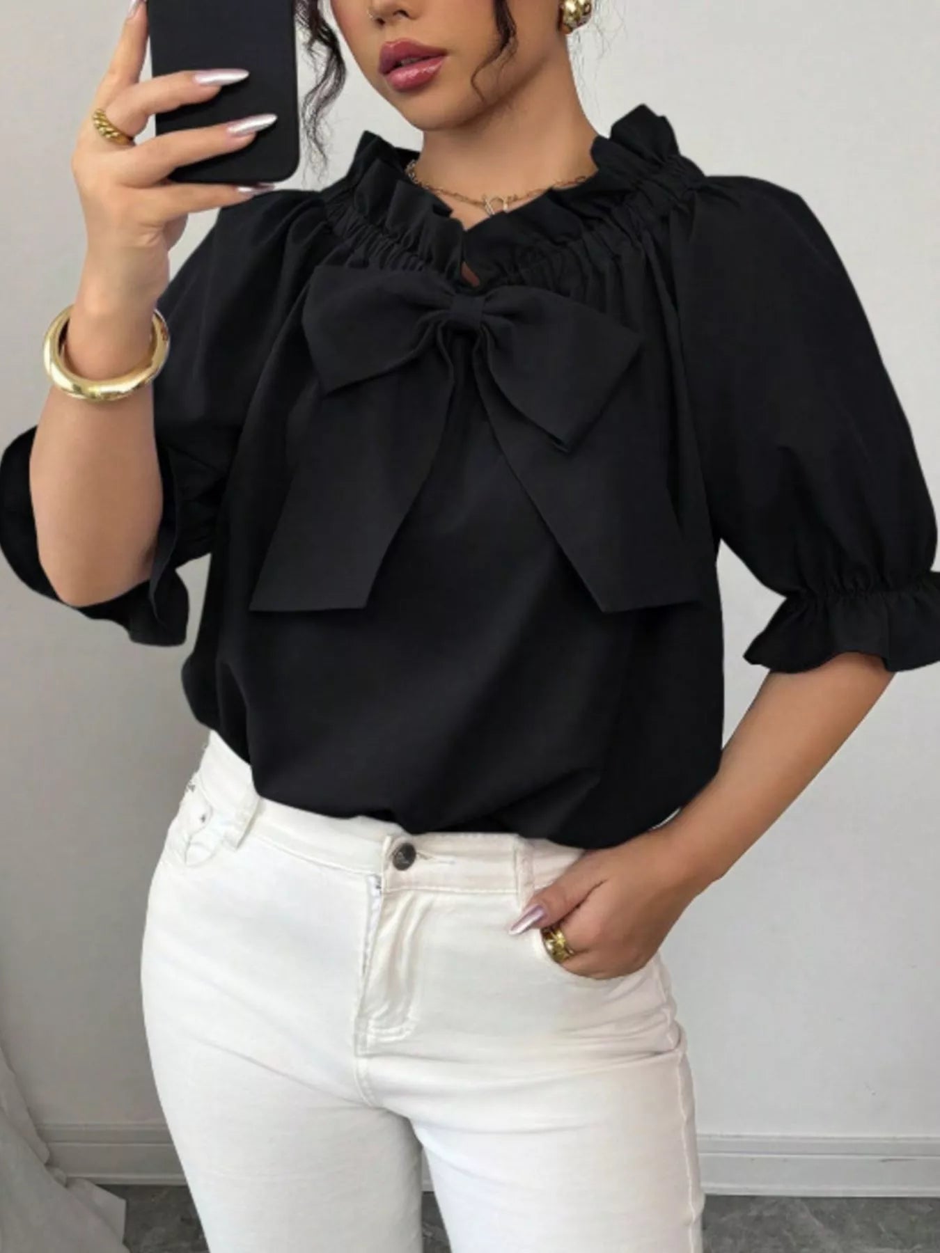 Bow Flounce Sleeve Blouse in black with a large front bow, ruffled neckline and puff sleeves.