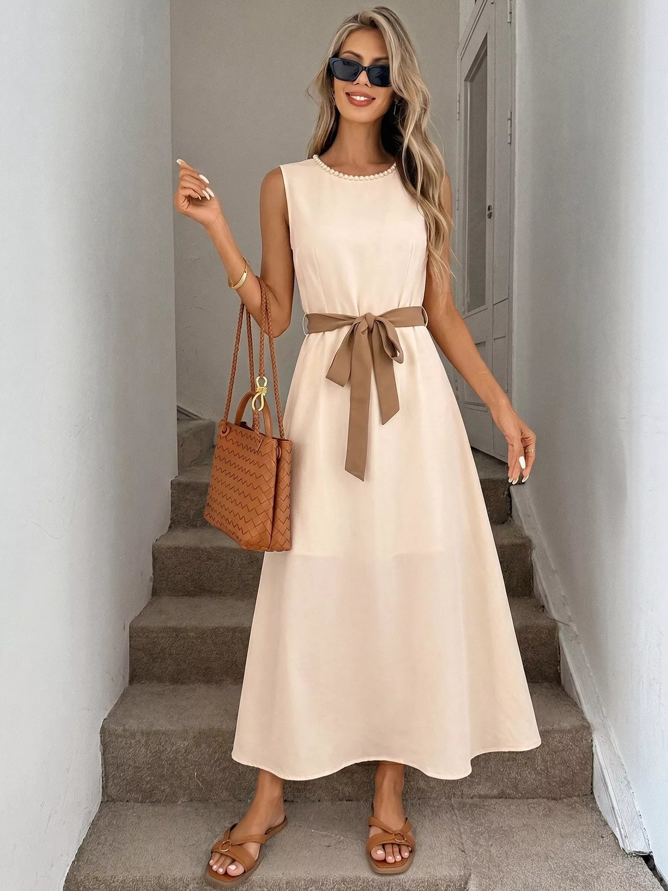 Cedar & Moore Sleeveless A-line midi dress in beige with tan waist sash and pearl neckline