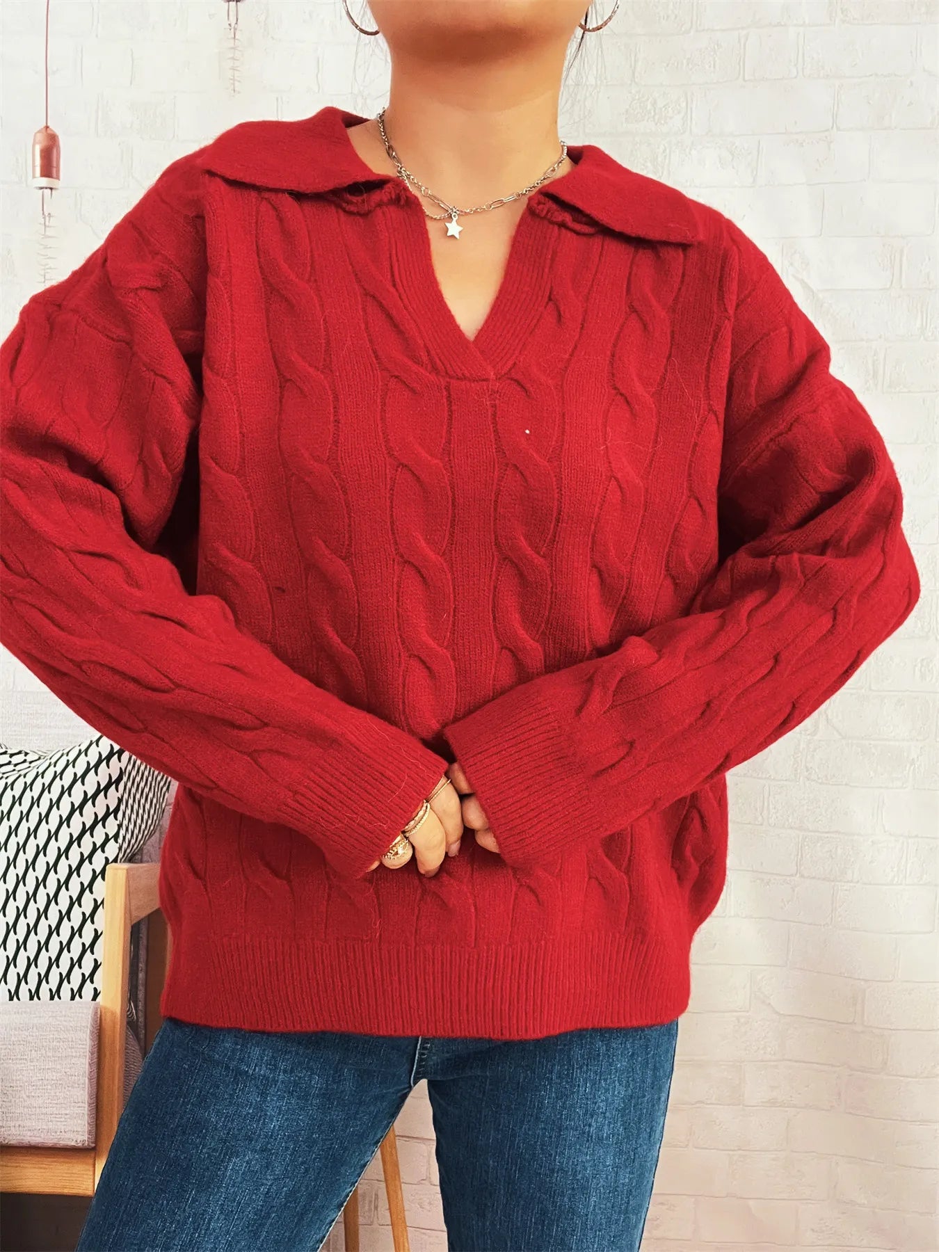 Red cable-knit V-neck Johnny collar sweater with raised cable texture and ribbed cuffs
