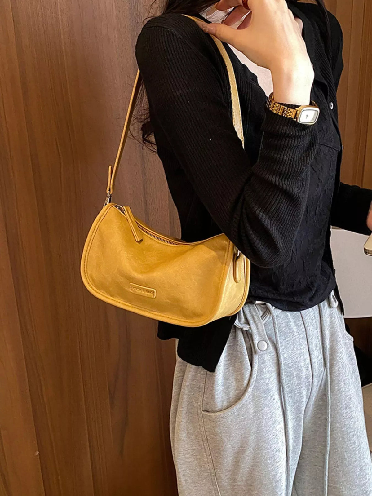 Mustard yellow leather crossbody bag with adjustable strap and zip top