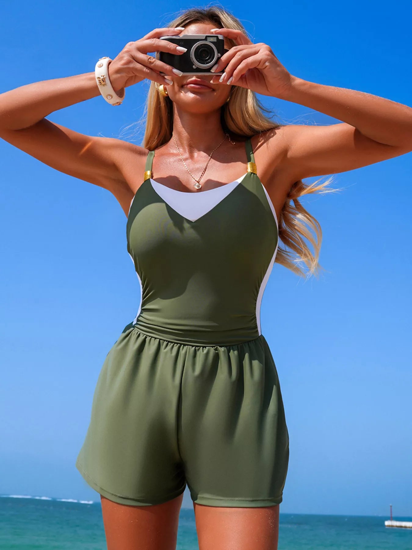 Color-block adjustable-strap one-piece swimsuit in olive green with white panels and gold hardware