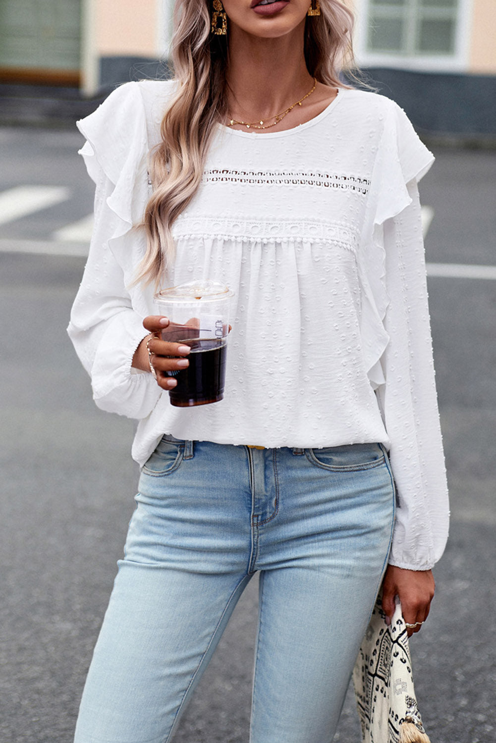 Ruffled round-neck blouse in white with long sleeves and layered ruffle details