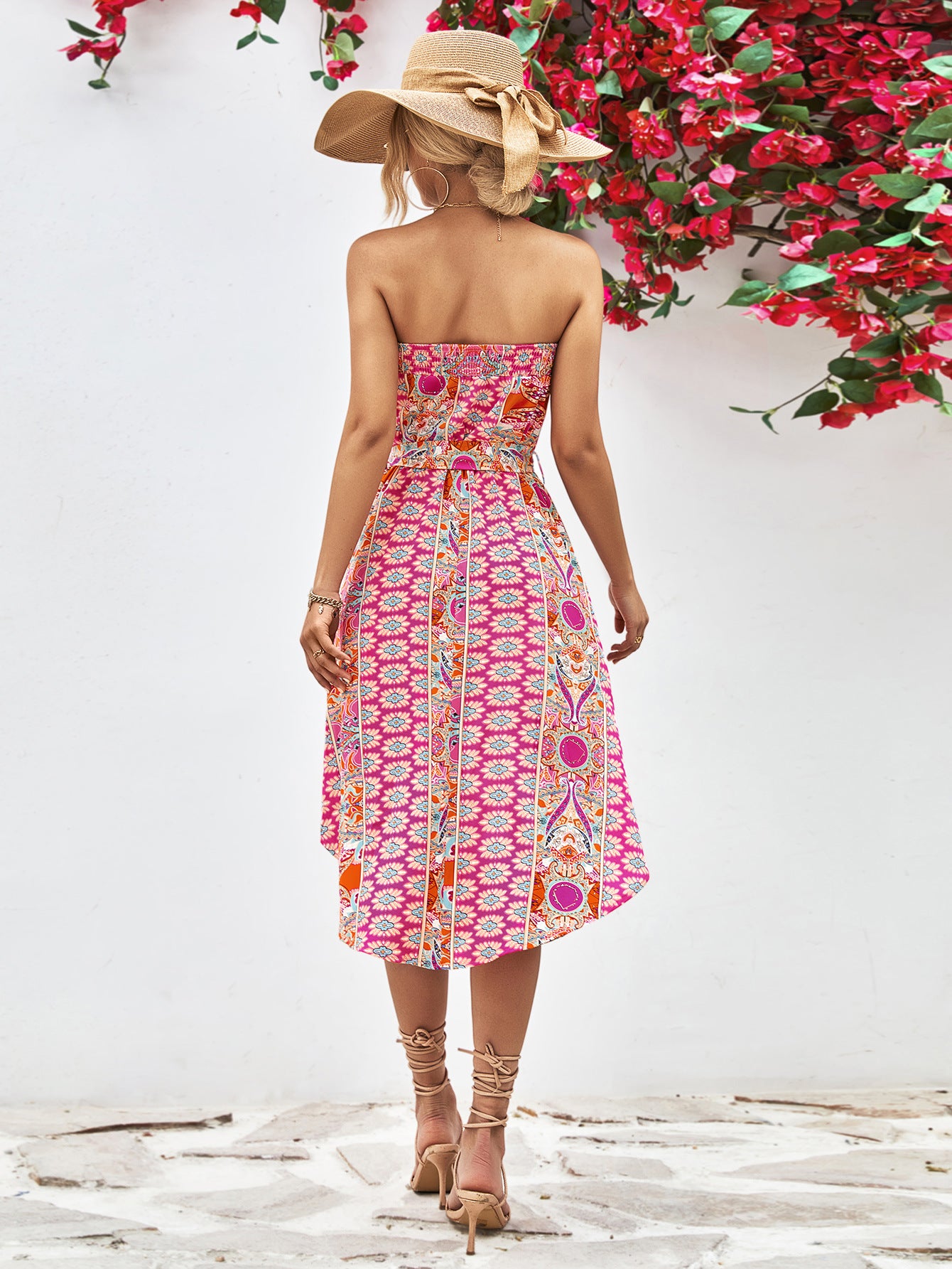 Hot pink strapless tie-belt dress with bold geometric print and gathered waist, midi