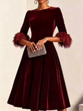 Wine velvet midi dress with feather cuffs, long sleeves and pleated skirt