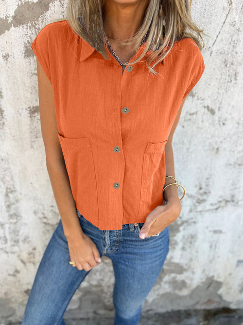 Orange button-down cap sleeve shirt with front buttons and chest pockets
